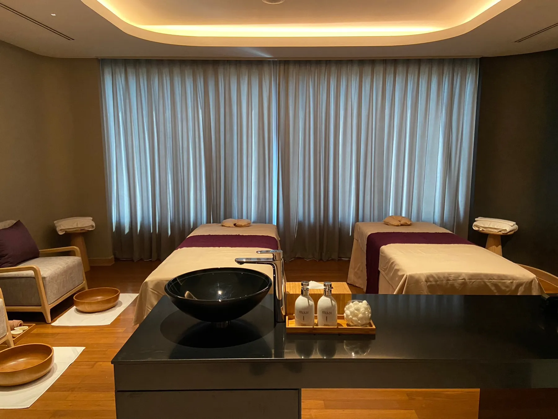 Maai Spa: a treatment suite with a black stone counter and vessel basin